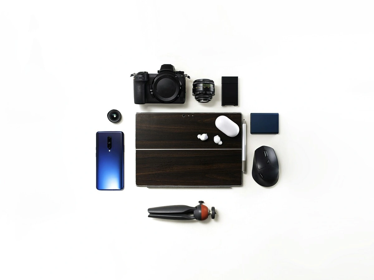 A matte-black power bank lying on a light bench with a coiled white USB-C cable beside it, the room behind out of focus.